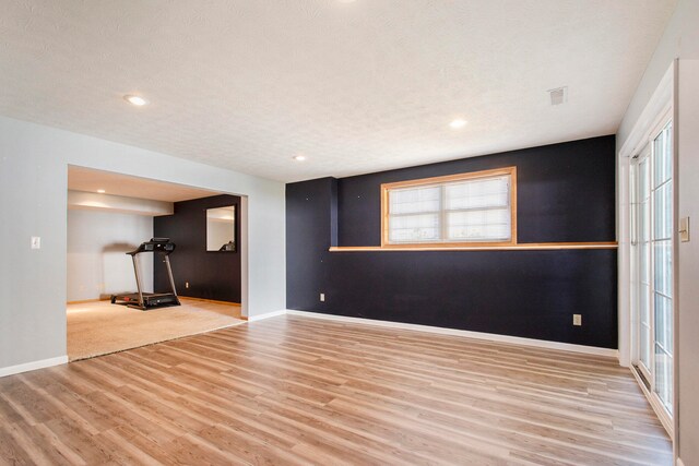 interior space with a textured ceiling and light wood-type flooring