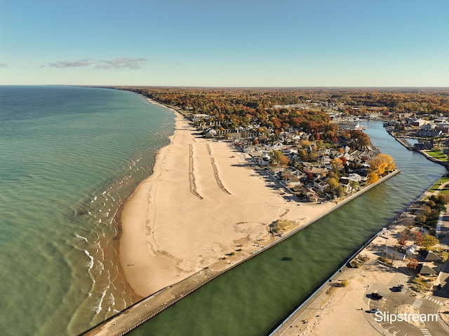 drone / aerial view with a beach view and a water view