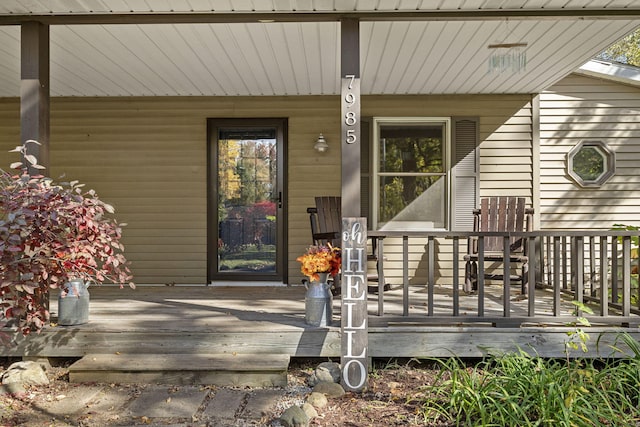 view of exterior entry with a porch