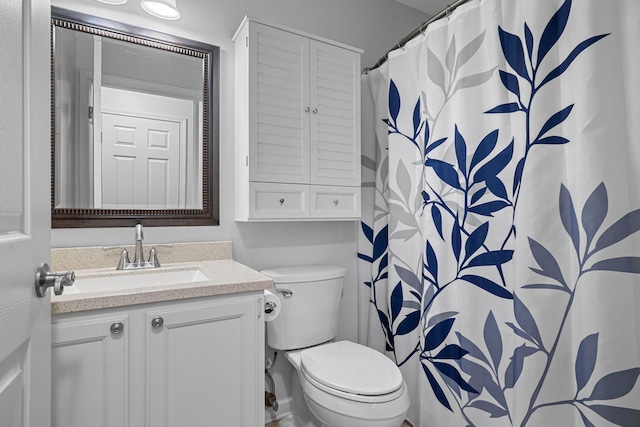 bathroom featuring toilet, a shower with curtain, and vanity