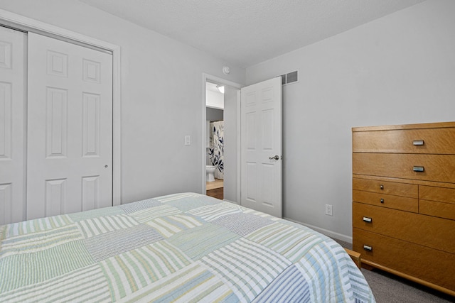 carpeted bedroom featuring a closet and a textured ceiling