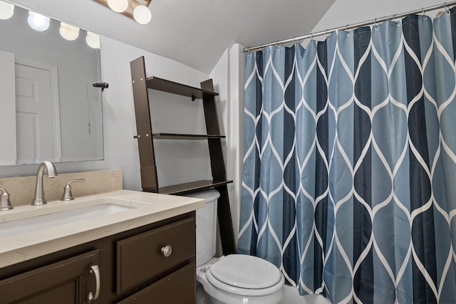 bathroom featuring vanity, a shower with shower curtain, and toilet