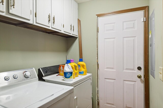 laundry room featuring independent washer and dryer and cabinets