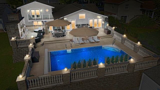 pool at night with a patio