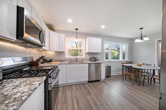 kitchen featuring sink, white cabinetry, stainless steel appliances, and light wood-type flooring