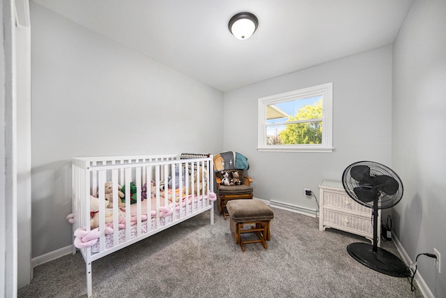 bedroom featuring baseboard heating, carpet floors, and a crib