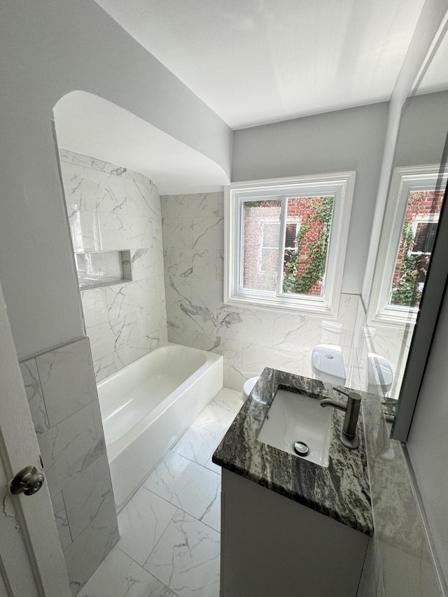 bathroom with vanity and a bath