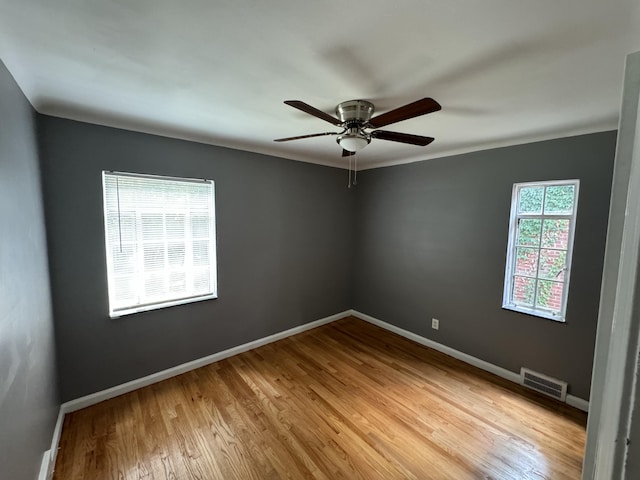 spare room with light hardwood / wood-style floors and ceiling fan