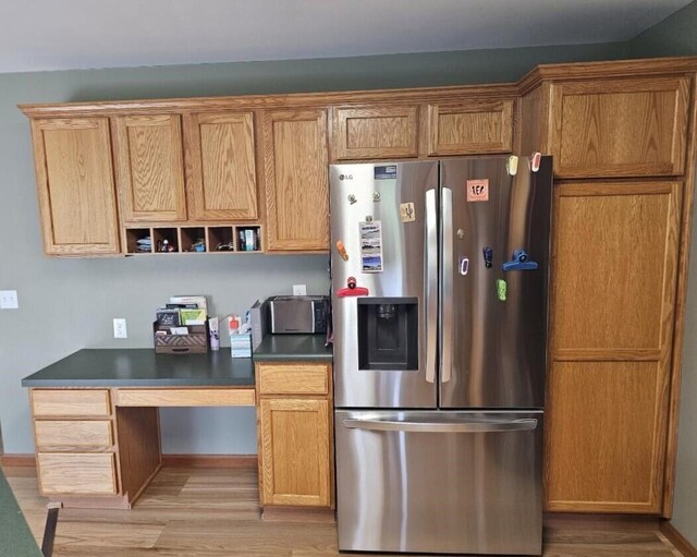 kitchen featuring light hardwood / wood-style floors and stainless steel fridge with ice dispenser