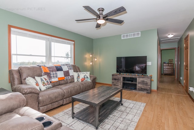 living room featuring light wood-type flooring and ceiling fan