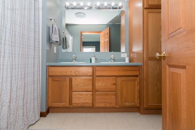 bathroom featuring vanity, curtained shower, and tile patterned flooring