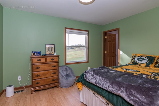 bedroom with hardwood / wood-style flooring