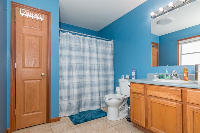 bathroom featuring vanity, toilet, a shower with curtain, and tile patterned flooring