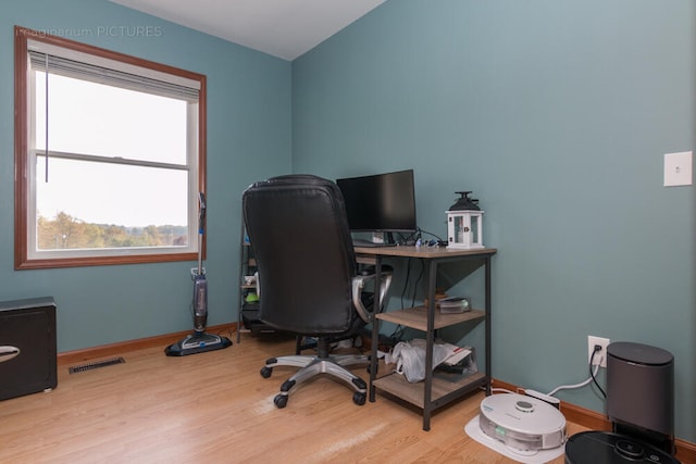 home office with wood-type flooring