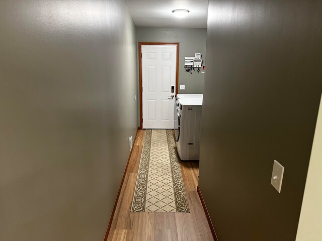 entryway with washing machine and dryer and light wood-type flooring