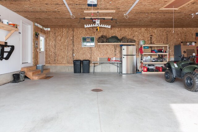 garage with stainless steel fridge