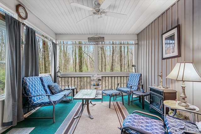 sunroom with wood ceiling and ceiling fan