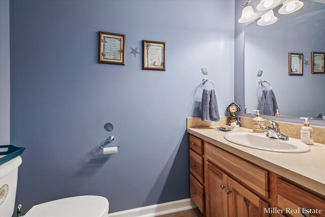 bathroom with toilet and vanity