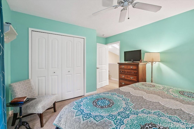 carpeted bedroom featuring a closet and ceiling fan