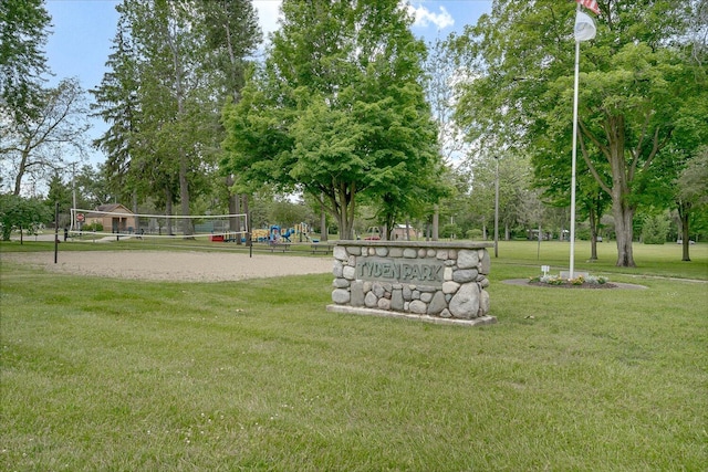 view of home's community featuring a yard and volleyball court