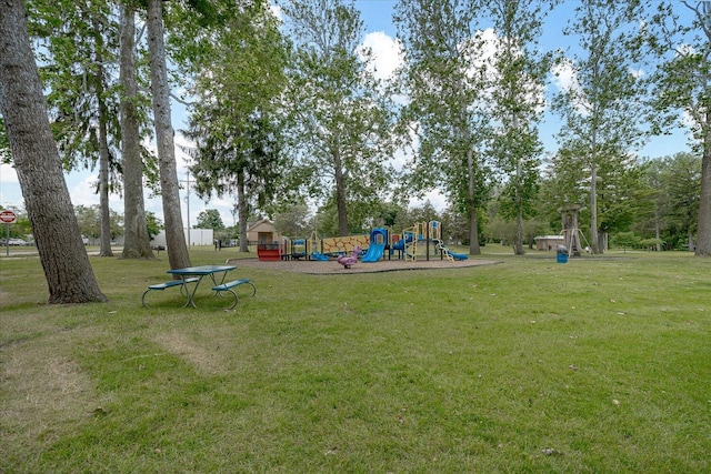 view of playground with a lawn