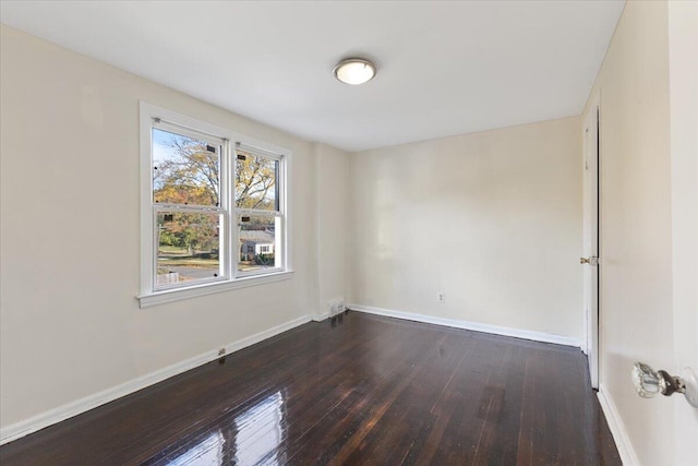 spare room featuring dark hardwood / wood-style floors