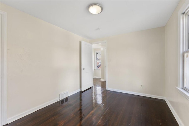 empty room with dark wood-type flooring