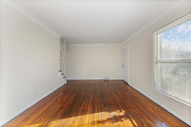 spare room featuring dark wood-type flooring