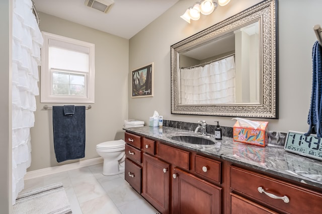 bathroom with vanity, toilet, and tile patterned floors