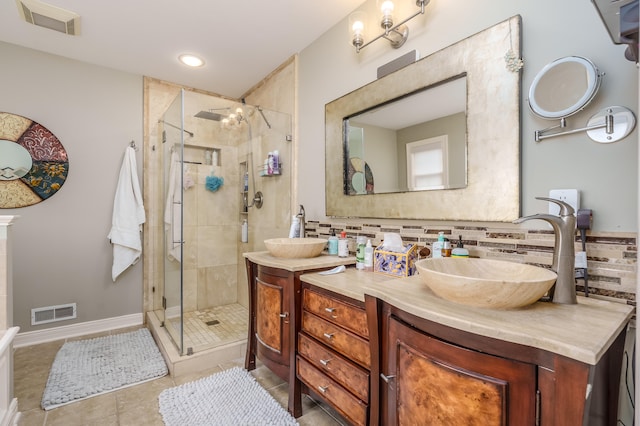 bathroom with vanity, backsplash, tile patterned floors, and walk in shower