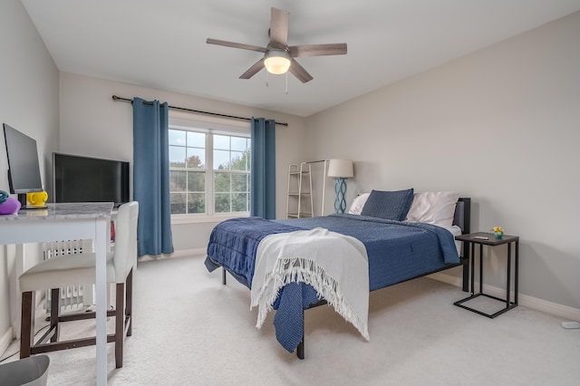 bedroom with ceiling fan and light carpet