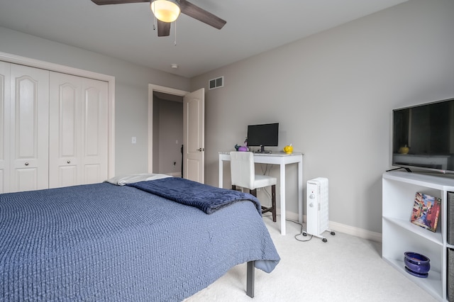 bedroom featuring light carpet, a closet, and ceiling fan