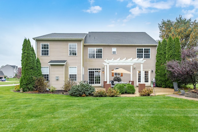 back of property with a patio area, a lawn, and a pergola