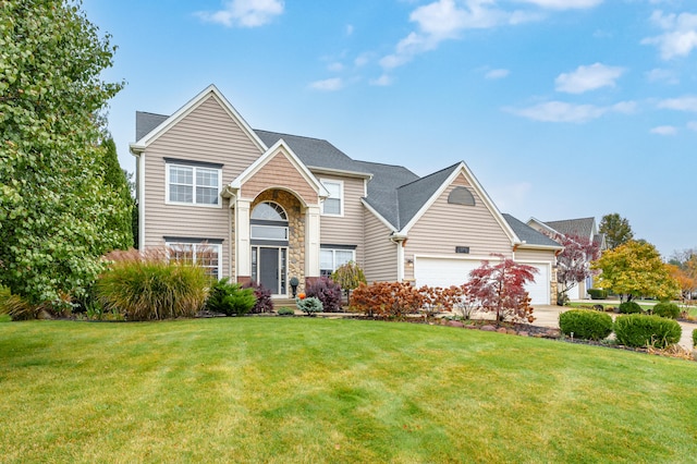 view of front of home featuring a front yard and a garage