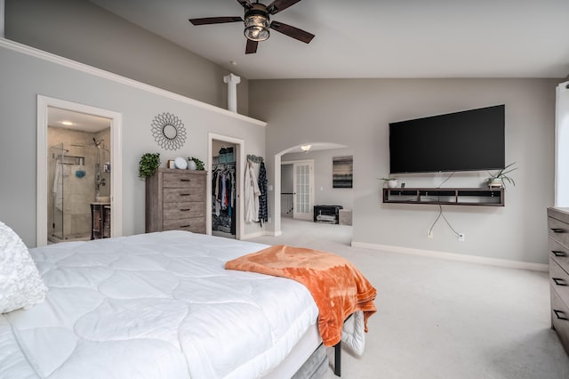 bedroom with a closet, light carpet, a walk in closet, ensuite bathroom, and ceiling fan