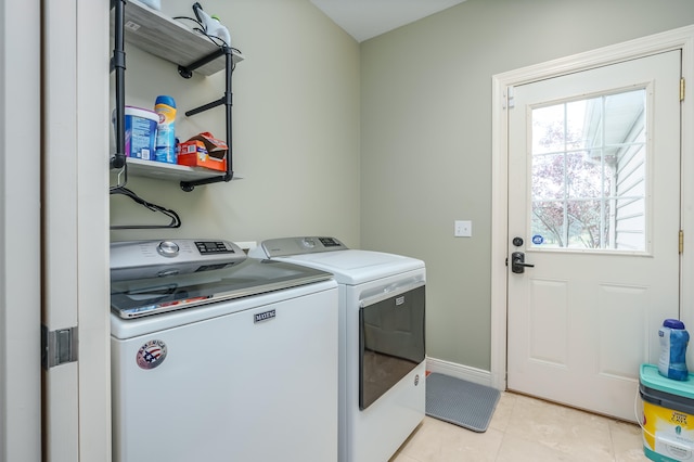 laundry area featuring separate washer and dryer and light tile patterned floors