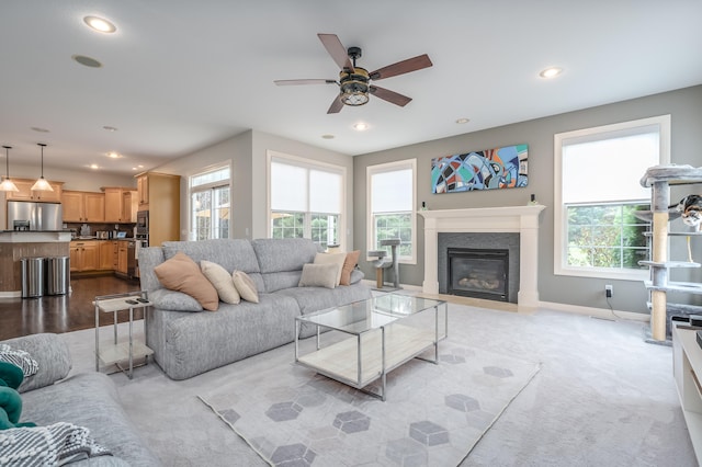 living room with a healthy amount of sunlight, light colored carpet, and ceiling fan