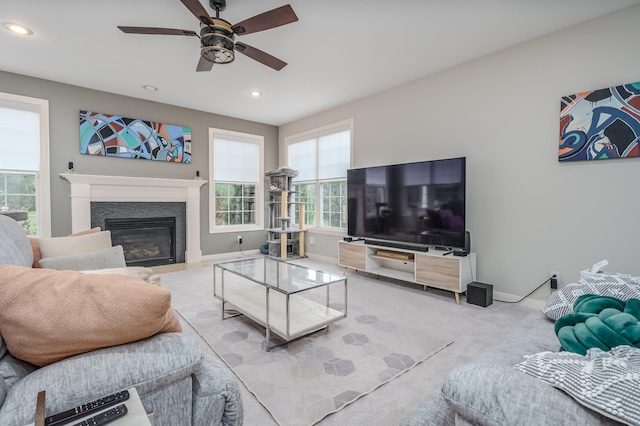 carpeted living room with ceiling fan and plenty of natural light