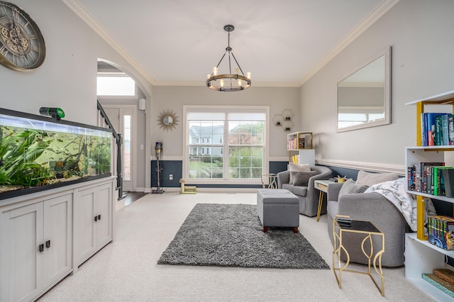 carpeted living room featuring crown molding and a notable chandelier