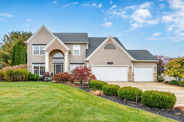 view of front property featuring a front yard and a garage