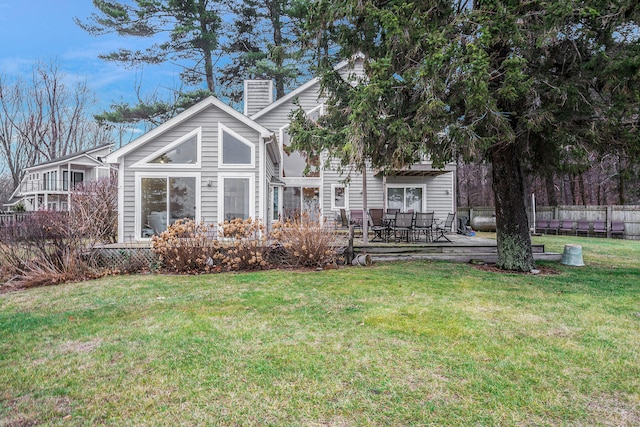 rear view of house featuring a lawn