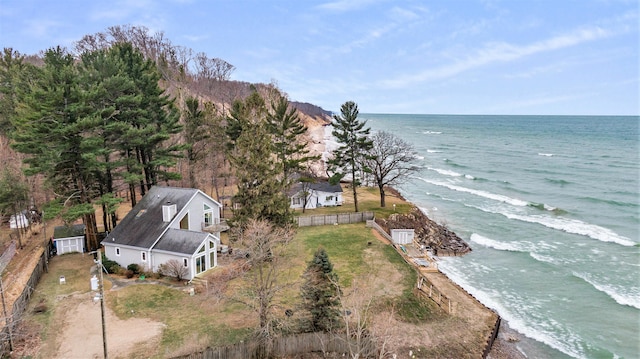 birds eye view of property with a water view and a view of the beach