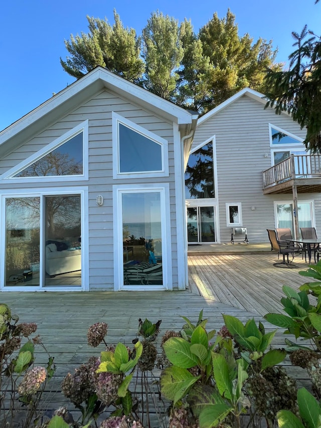 rear view of property featuring a wooden deck