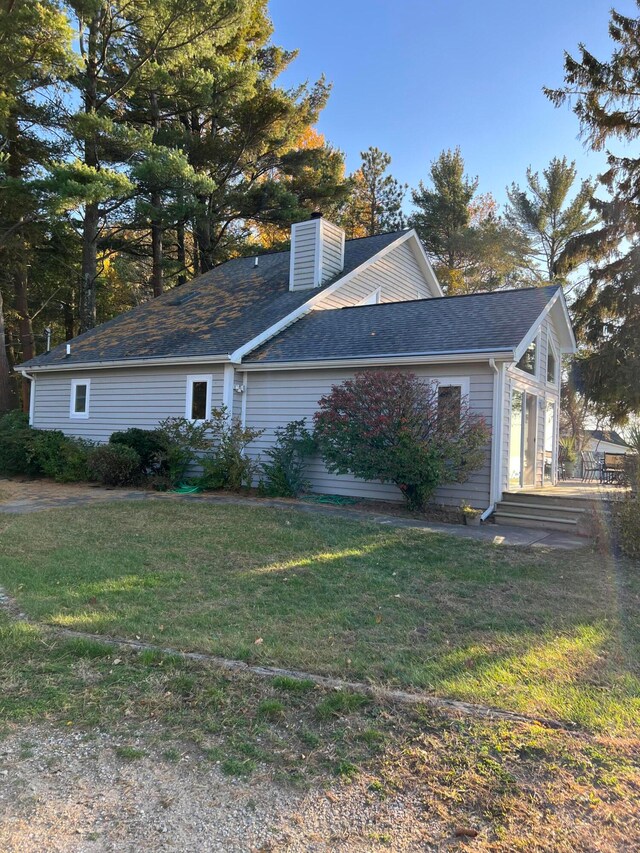 view of side of property with a yard