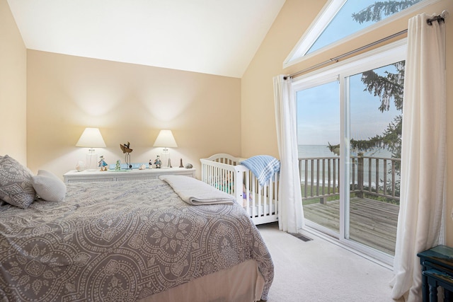 bedroom featuring multiple windows, access to exterior, carpet flooring, and vaulted ceiling