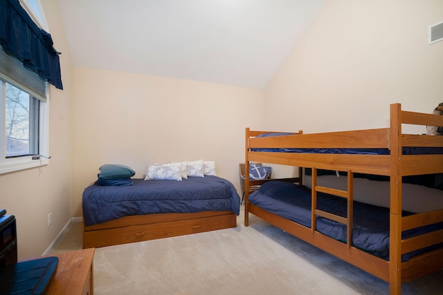 bedroom featuring lofted ceiling and carpet flooring