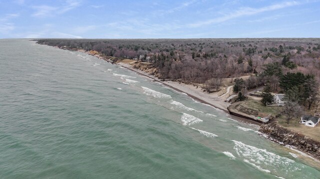 birds eye view of property featuring a water view and a beach view