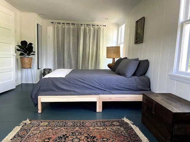 bedroom with dark hardwood / wood-style floors