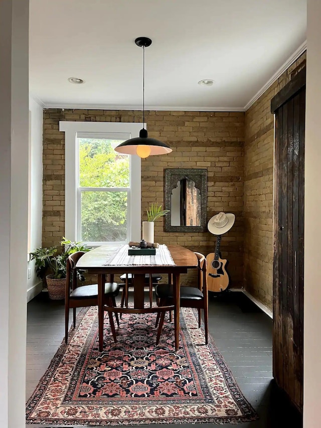 dining space with dark wood-type flooring and ornamental molding