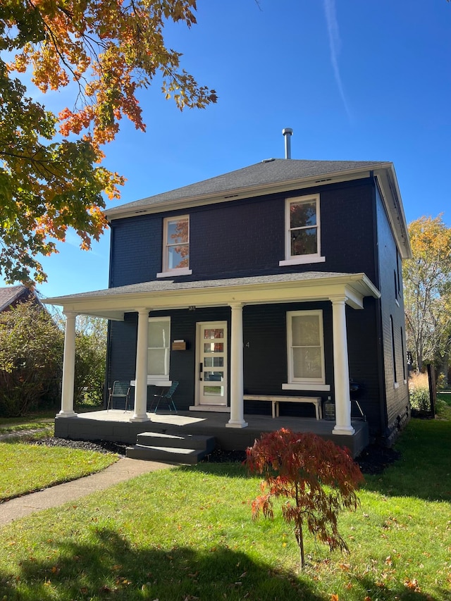 view of front of property featuring a front lawn and a porch